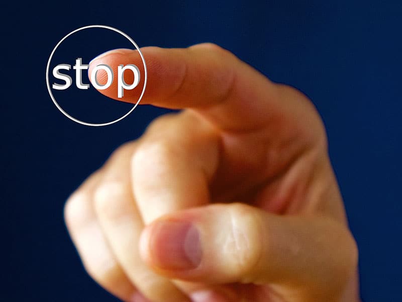 Fionger pointing at the word stop to illustrate an article on storing fat